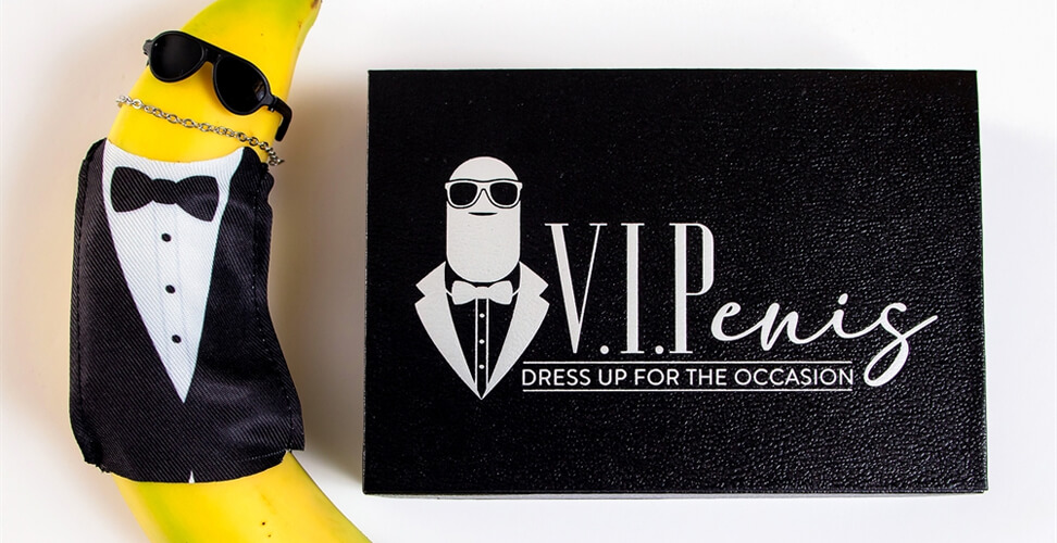 Novelty penis clothing on banana with tuxedo, sunglasses & chain, next to V.I.Penis gift box &ndash; humorous adult gag gift