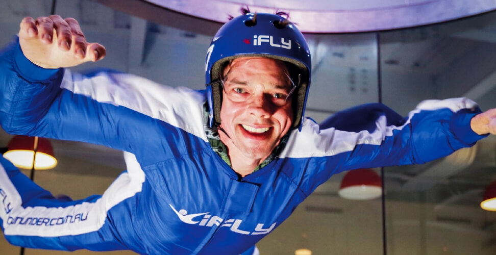 Man enjoying indoor skydiving experience &ndash; thrilling wind tunnel flight adventure for adrenaline seekers