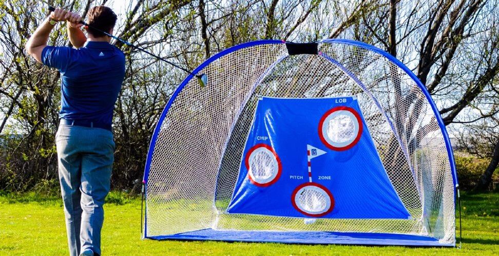 Golfer hitting a ball into the PGA Tour Pro Training Net, perfect practice gear for improving golf swing at home