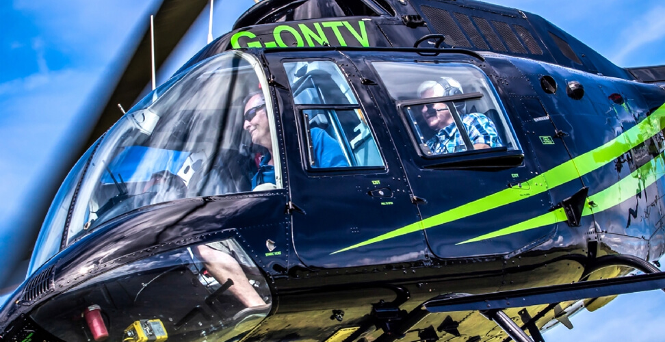 Passenger enjoying a helicopter ride gift experience &ndash; thrilling aerial adventure, sightseeing flight, and unforgettable experience