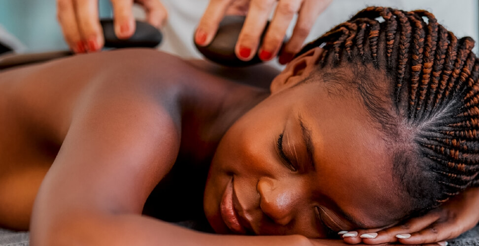 Woman enjoying a relaxing hot stone massage &ndash; spa treatment, stress relief, wellness experience, and pampering session