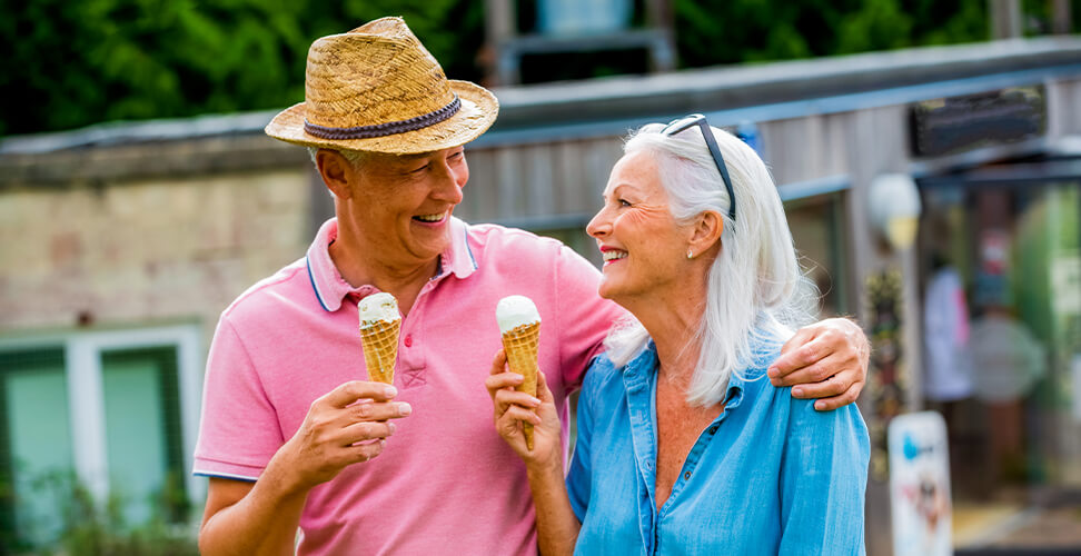 Grandparents enjoying a getaway experience with ice creams, relaxing holiday and fun travel for seniors