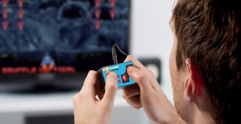 Man playing plug and play retro gaming console on TV, classic video games for nostalgic Christmas gift idea