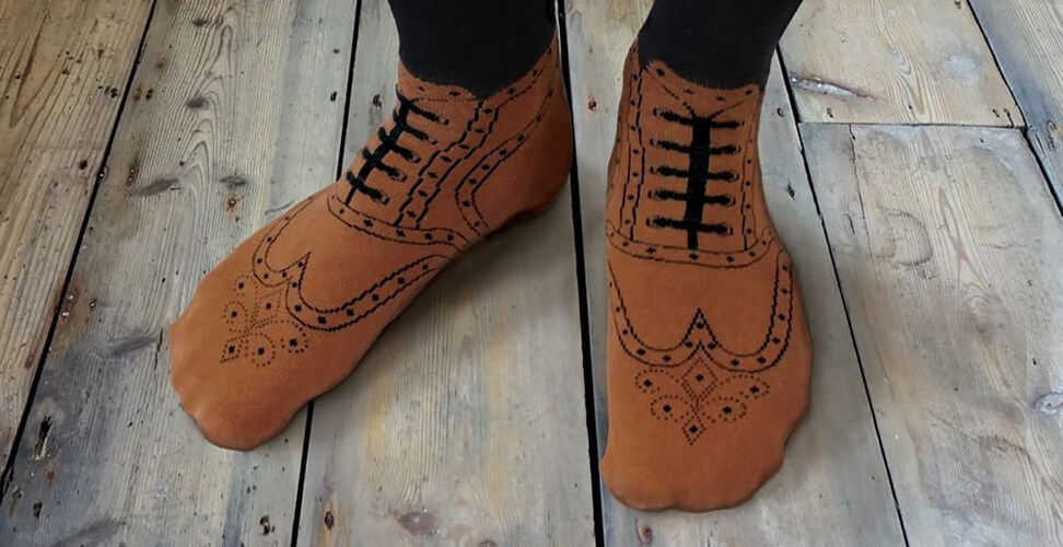Man wearing novelty socks designed like brown brogue shoes – funny and stylish gift idea for men