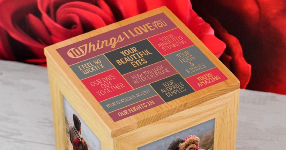 A wooden photo cube with a "10 Things I Love About You" design on top, surrounded by red roses.
