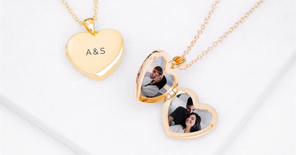 Two gold heart lockets, one closed with initials 'A & S', one open revealing a couple's photos.