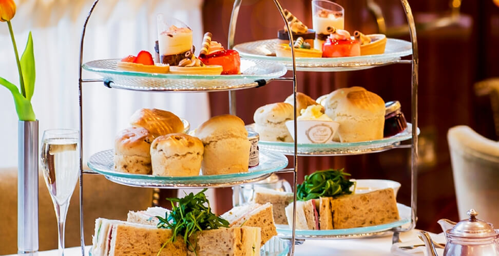 Three-tier afternoon tea set – elegant tea experience with cakes, sandwiches, and treats, perfect for gifts or special occasions