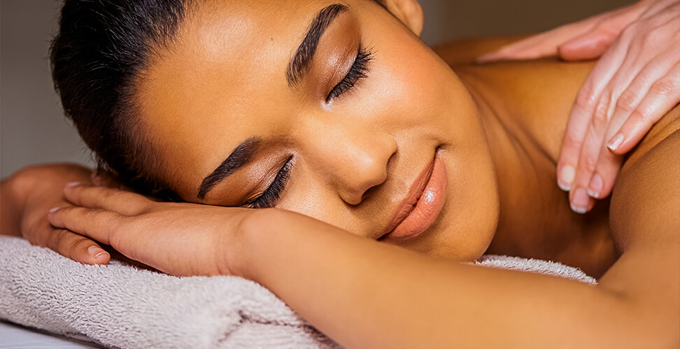 Relaxed woman receiving a massage – spa experience, wellness treatment, stress relief, and pampering session for relaxation