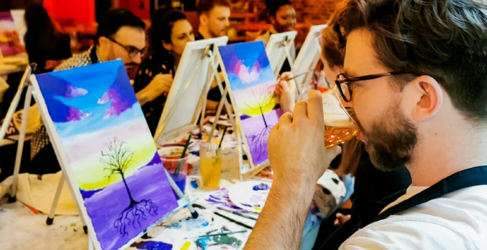 Man drinking beer at a sip and paint experience &ndash; fun creative gift idea for him
