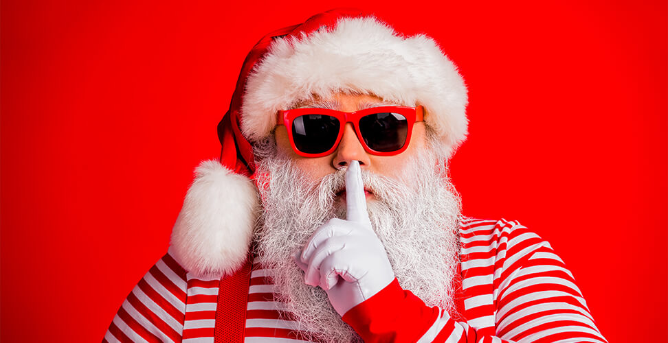 Santa Claus with finger on lips &ndash; playful Secret Santa or holiday gift theme, fun festive Christmas illustration 