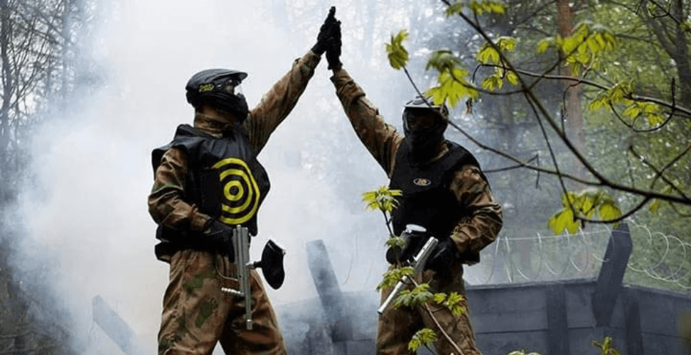 A couple of people in military gear giving each other a high five