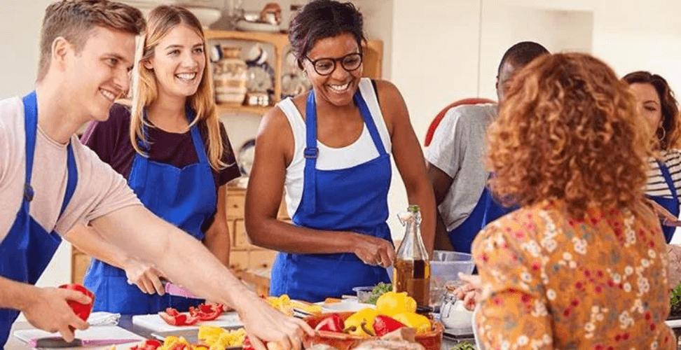 A group of people in aprons smiling