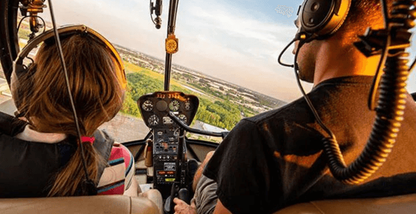 A person and person in a helicopter