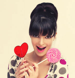 Lady holding heart shaped lollipops